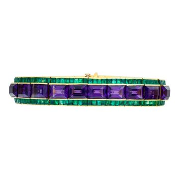 Amethyst and emerald bracelet in 18k yellow gold. Approximately 50 carats of emerald cut amethysts and 20 carats of square emeralds. Deep vibrant colors, all stones well matched. 7 inch length.