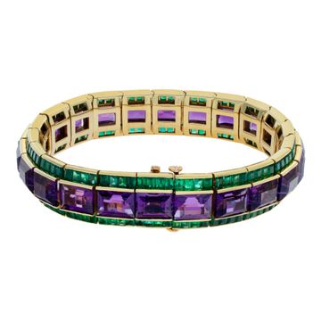 Amethyst and emerald bracelet in 18k yellow gold. Approximately 50 carats of emerald cut amethysts and 20 carats of square emeralds. Deep vibrant colors, all stones well matched. 7 inch length.