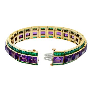 Amethyst and emerald bracelet in 18k yellow gold. Approximately 50 carats of emerald cut amethysts and 20 carats of square emeralds. Deep vibrant colors, all stones well matched. 7 inch length.