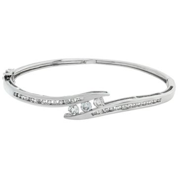 Bangle bracelet with round brilliant cut diamonds set in 14K white gold.