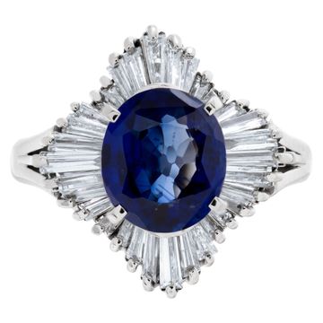 Deep blue oval sapphire ring with baguette diamonds in platinum