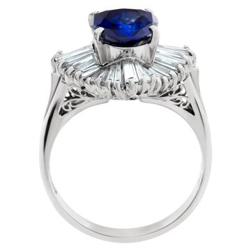 Deep blue oval sapphire ring with baguette diamonds in platinum