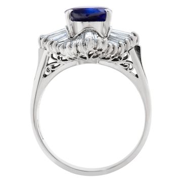 Deep blue oval sapphire ring with baguette diamonds in platinum