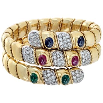 Egyptian revival, flexible diamonds "Serpenti" bracelet with cabochon rubies, sapphires and emeralds, in 18K white & yellow gold. Round brilliant cut diamonds total approx. weight: 4.25 carats.