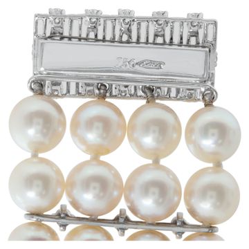 Four strand pearl bracelet with 18k white gold and diamond clasp and stations. 7.5mm pearls