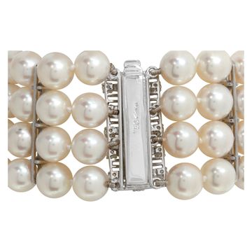 Four strand pearl bracelet with 18k white gold and diamond clasp and stations. 7.5mm pearls