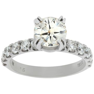 GIA certified round brilliant cut 1.37 carat diamond (O-P range, very light brown, SI clarity) ring set in platinum