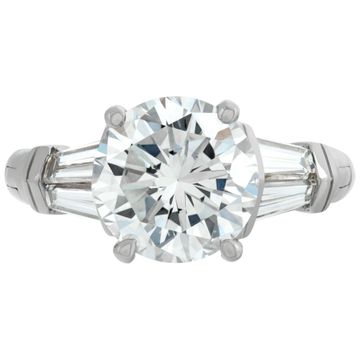 GIA Certified round brilliant cut 3.09 carat diamond, H Color, VS2 clarity set on a "FINGER MATE" platinum & 14K white gold setting with 4 tapered baguettes