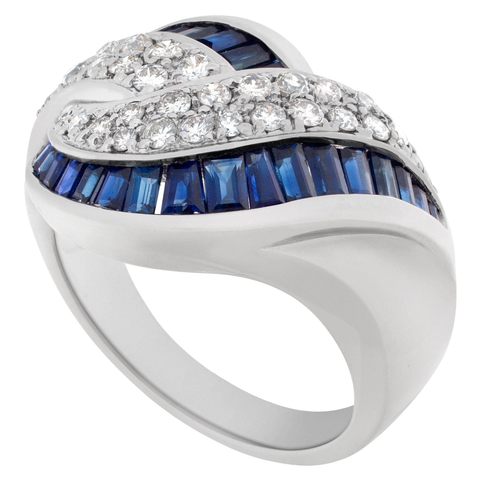 Criss-Cross sapphire & diamond ring in 14K white gold. Approx 1 carat tapered emerald cut sapphire and 0.75 carat full cut round diamond.