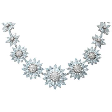 Signed "Asprey" London, Daisy Heritage collection, brilliant cut blue topaz and diamonds necklace and earrings parure, set  in 18k white gold.