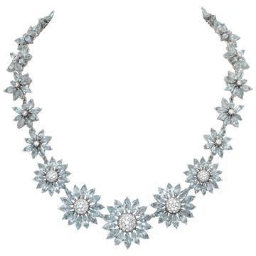 Signed "Asprey" London, Daisy Heritage collection, brilliant cut blue topaz and diamonds necklace and earrings parure, set  in 18k white gold.