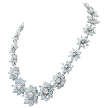 Signed "Asprey" London, Daisy Heritage collection, brilliant cut blue topaz and diamonds necklace and earrings parure, set  in 18k white gold.