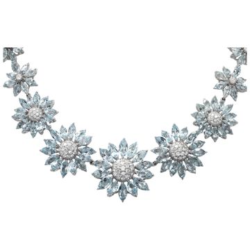 Signed "Asprey" London, Daisy Heritage collection, brilliant cut blue topaz and diamonds necklace and earrings parure, set  in 18k white gold.