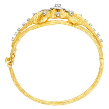 Vintage hinged diamonds bangle bracelet in bark finished 18k yellow gold. Round & baguettes cut diamonds total approx.weight: 1.50 carat